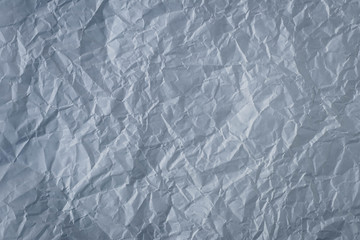 Crumpled gray paper background. Textured effect. Messy wrinkled parchment. Dark grey sheet texture.