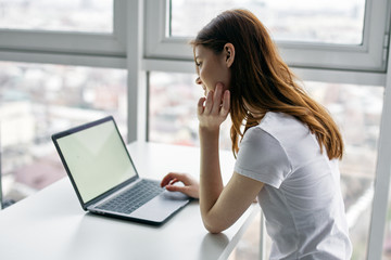 young woman working on laptop at home