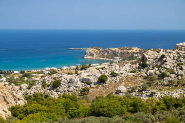 Scenic view at Stegna beach on Geek island Rhodes with rocks in the foreground and the mediterranean sea in the background