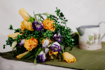 A bouquet of yellow roses with green balls