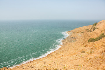 View of Dead Sea coastline at sunset time in Jordan. Salt crystals at sunset. Dead sea landscape with minehral structures.