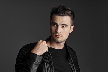 portrait of young man with hands in pockets