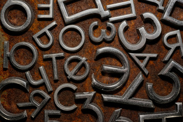 Assorted metal cyrillic letters on a rusty background