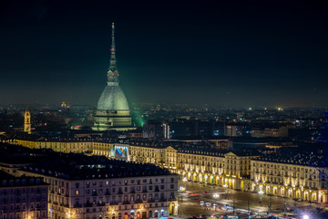 Scenic night cityscape of Turin with the Mole Antonelliana and Vittorio square lighted for the new year celebrations. Italy