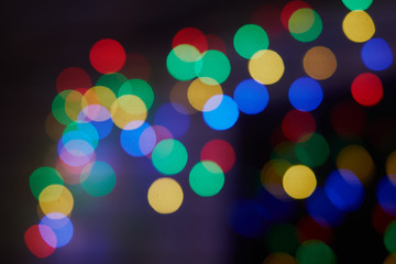 Obraz premium Various multicoloured bubles close up in dark light background, festival celebrities photo, bubbles,Christmas, New Year, Colorful bokeh. Bokeh, abstract light background.Holidays background.Festive