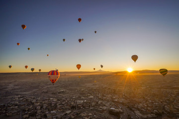 CAPPADOCIA, TURKY - 19 December 2019 : Aerial beautiful landscape view of balloons flight in the morning with sunrise sky background