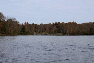 A calm peaceful view of the lake on a fall day.