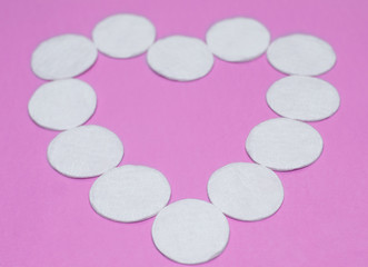 Cleansing cotton pads on purple background, Makeup Love Concept