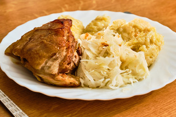 Roast pork knuckle with cabbage and dumplings