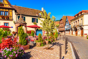 Fototapeta na wymiar Restaurant tables on village square of Kintzheim which is located on famous Alsace wine route, France
