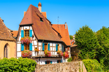 Fototapeta na wymiar Colorful typical Alsatian house on street in picturesque Kaysersberg village, Alsace Wine Route, France