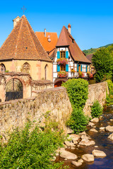 Fototapeta na wymiar Colorful typical Alsatian house on street in picturesque Kaysersberg village, Alsace Wine Route, France