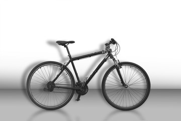 Fototapeta na wymiar Black bicycle on sparse monochrome background