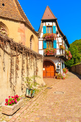 Colorful typical Alsatian house on street in picturesque Kaysersberg village, Alsace Wine Route, France