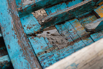 Decrepit old row boats in the harbor in Naples, Italy during the morning following a rain storm.