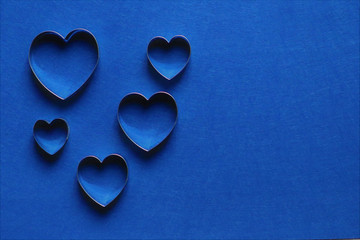 Fototapeta premium many hearts in trendy color of year on classic blue background. Copy space.
