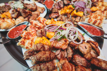 Variety assortment of traditional main course meat barbecue grill dishes of Caucasian cuisine, with...