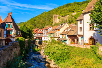 Beautiful traditional colorful houses on canal bank in picturesque Kaysersberg village, Alsace wine region, France
