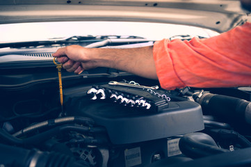 Hands of car mechanic working in auto repair service
