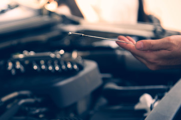 Hands of car mechanic working in auto repair service
