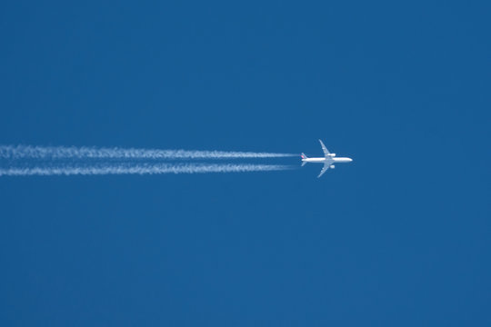 Trail From The Plane With Two Enigine The Blue Sky.