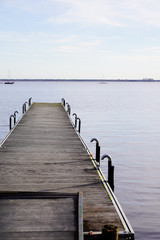 Fototapeta premium wooden pontoon pier at sunrise lake medoc of Maubuisson Carcans France