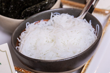 Clear noodles wax in a deep bowl