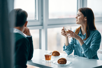 young couple having breakfast in cafe