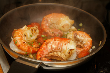 King prawns in a pan with tomatos and herbs