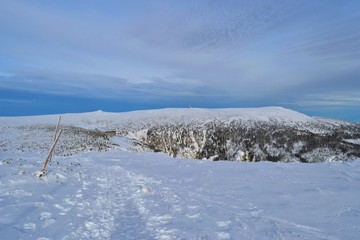 Krkonose mountains covered with snow. Hotel Labska bouda and Snezne Jamy in the distance.