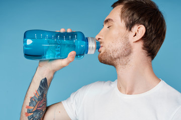 man drinking water from bottle