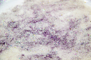 A purple glitter with sugar. Composition with glitter and sugar against background. Beautiful and textured background.