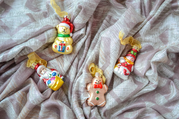 Four New Year's toys on silver fabric