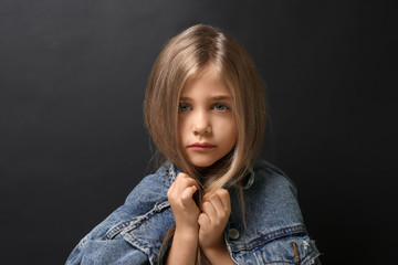 Fototapeta premium Cute little girl on dark background