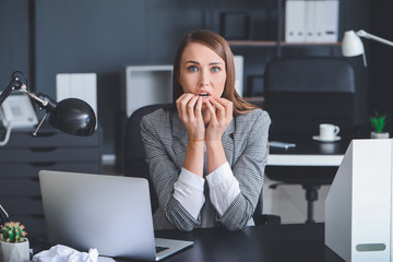 Worried young woman in office