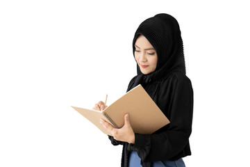 Portrait of beautiful Asian muslim student holding a book and pencile, Muslim student thinking.  Isolated on white background.