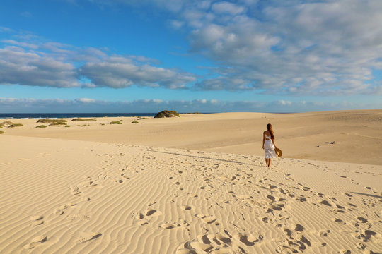 Stunning view of woman walking on Corralejo Dunas beach, Fuerteventura, Canary Islands