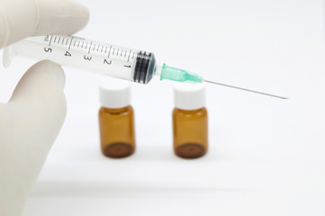 Disposable syringe, latex gloves and vials isolated on white background