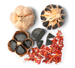 Composition with black garlic on white background