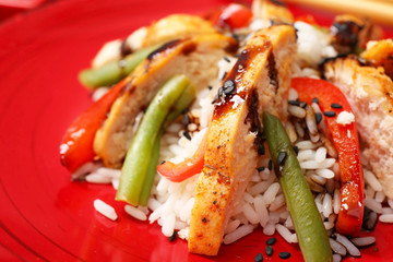 Plate with tasty rice, chicken and vegetables, closeup