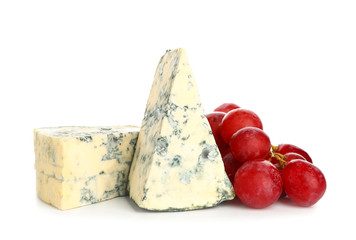 Tasty cheese with grapes on white background