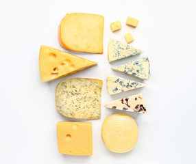 Assortment of fresh cheeses on white background