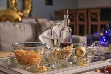 Table with terrible mess in room after New Year party