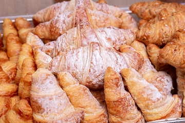 Fresh croissants with filling and sugar powder