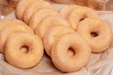 Doughnuts in sugar crumb on parchment