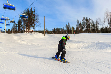Ski resort Levi, Lapland, FinlandCute, young boy snowboarding