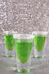 Three glasses with green drinks
