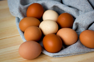 Whole and broken raw chicken eggs on a plate on a table yolk protein follows Easter eggs recipe food