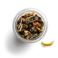 Green tea with natural aromatic additives. Top view on white background