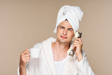 woman in bathrobe applying cream on her face